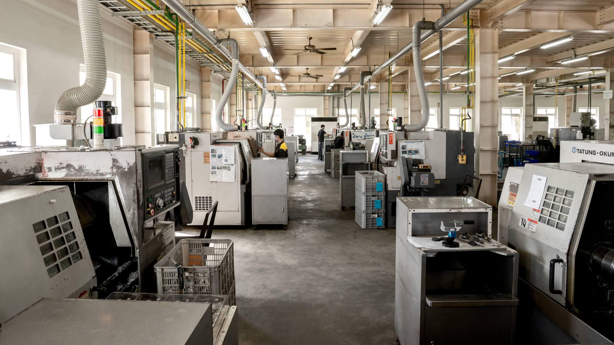 Automated CNC machining facility at JoinCast featuring row of high-precision lathes operated by a dedicated manufacturing team for international OEM brands.