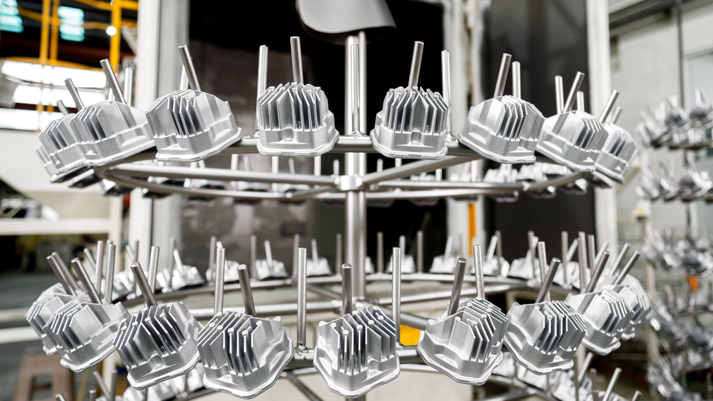 Precision-engineered aluminum die cast LED heat sinks arranged for automated Shot Blasting to ensure optimal thermal dissipation for high-power lighting fixtures.