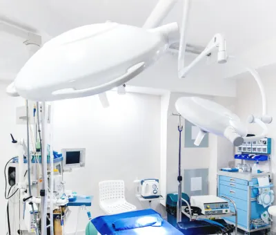 Precision aluminum die cast surgical lighting arm and equipment mounts installed in a modern sterile operating room environment.
