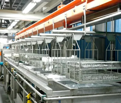 Fully automated surface treatment line providing in-house chemical immersion, trivalent chromium treatment, and preparation for aluminum die-cast parts.