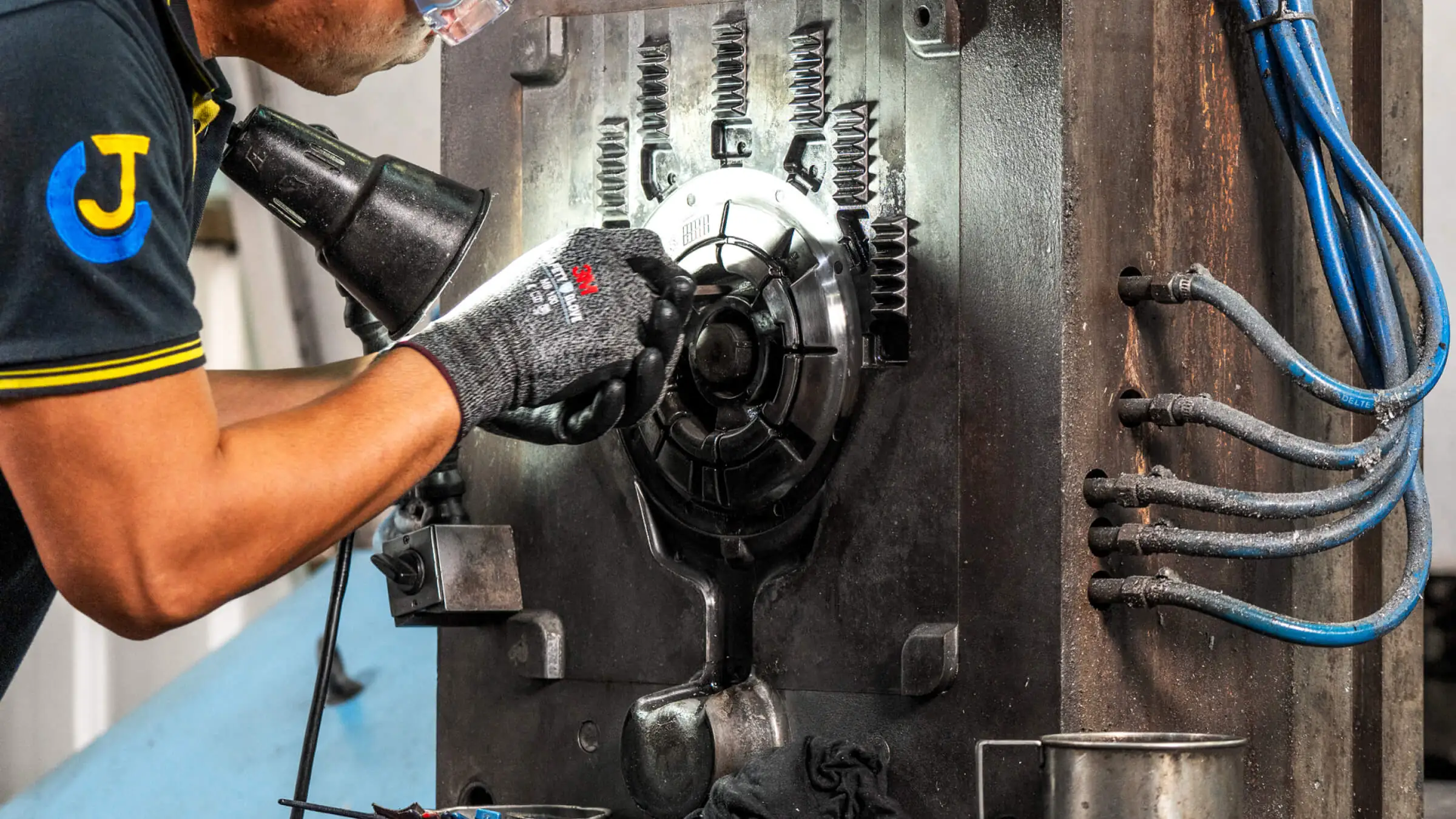 Expert JoinCast technician performing precision maintenance and manual adjustment on a high-pressure aluminum die casting mold.