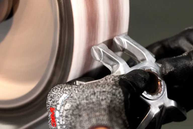 Expert hand-finishing of internal geometries on aluminum die cast parts to remove flash and maintain dimensional accuracy before surface treatment.