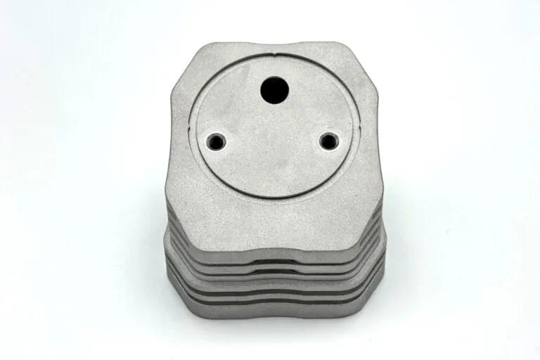 Stacked raw ADC-12 aluminum die castings featuring complex 3D fin geometries to maximize surface area for heat dissipation.