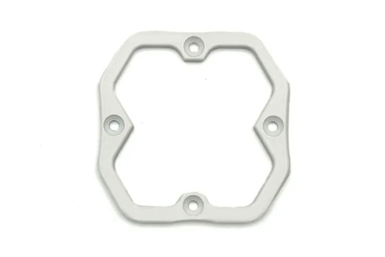 Close-up of a white powder-coated aluminum die-cast frame illustrating uniform coating thickness and clean edge definition.